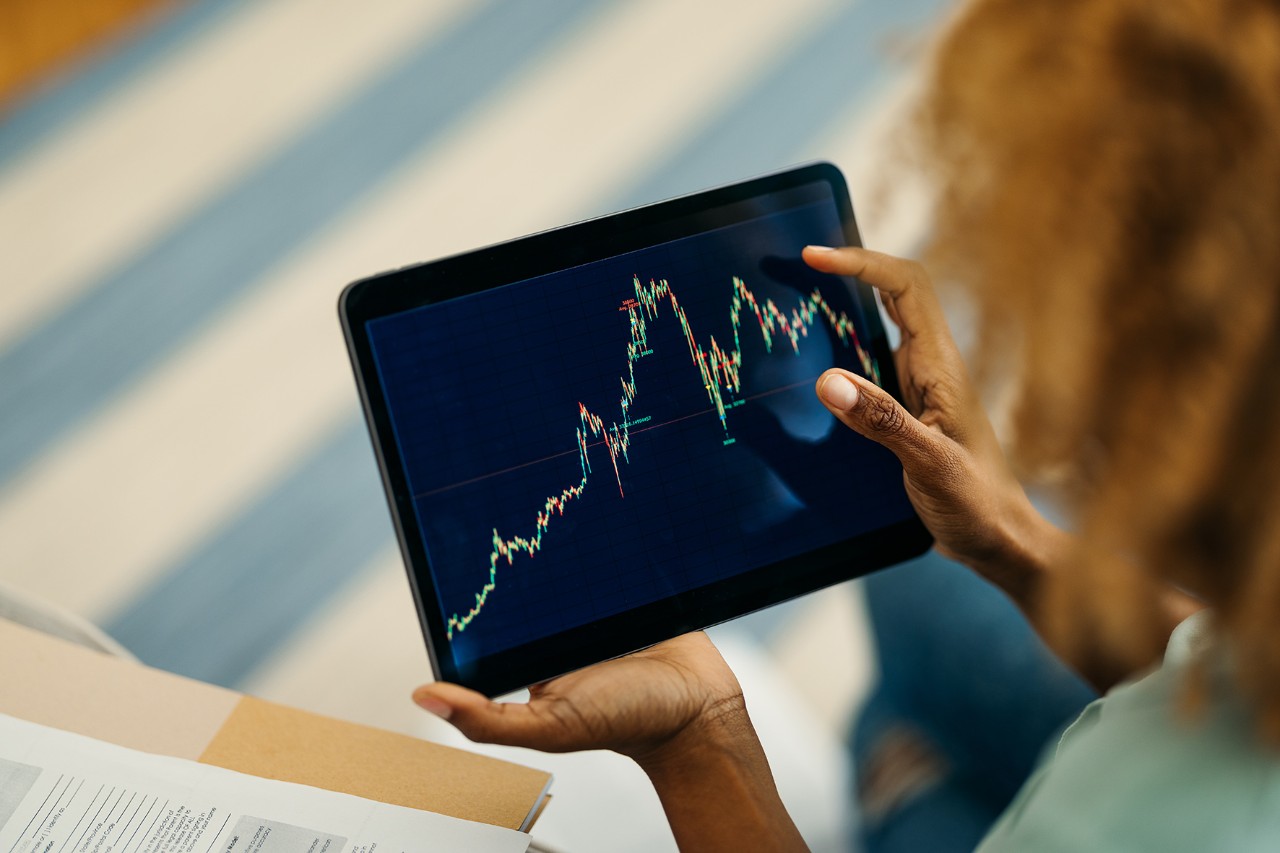 A woman watching a graph on a tablet