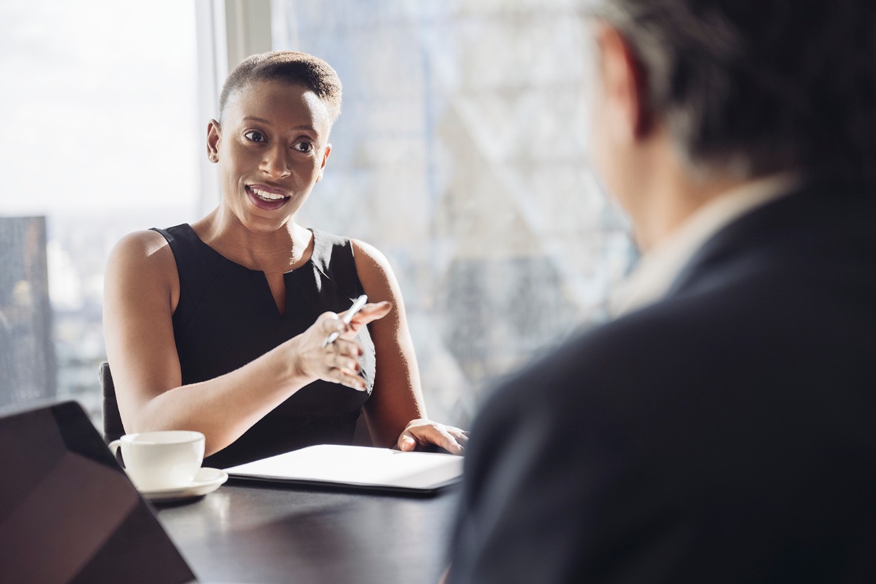 Woman talking in a meeting with a man